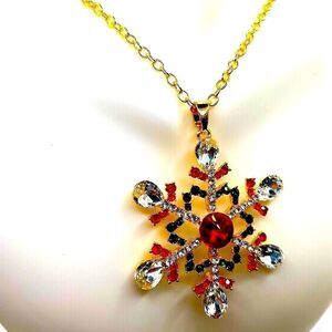 Bold statement long gold toned red and green rhinestone snowflake necklace